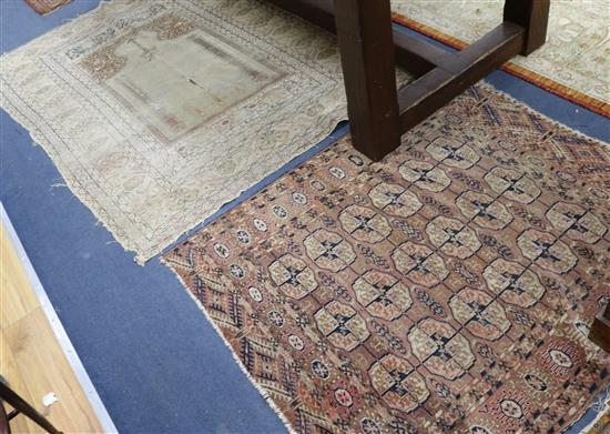 A Bokhara red ground rug and two Persian rugs (worn)